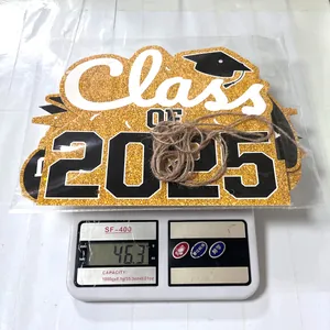 Close-up of Class OF 2025 glitter graduation sign showing weight of 46.3g on a digital scale