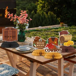 Wild West themed party honeycomb centerpieces featuring saloons and cowboy wagons on a table