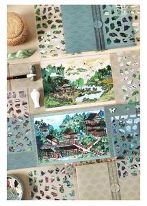 Detail of vintage Chinese landscape stickers with ink wash art and crane motifs