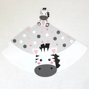 Flat lay of a zebra-themed paper party hat template on a white wooden background