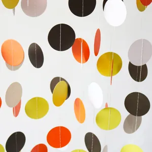 Detail of colorful paper star and circle garlands for Thanksgiving and birthday party decor