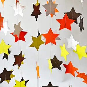 Detailed close-up of 3D star and circle paper garland with vertical white stitching