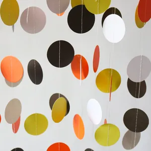 Close-up of autumn-themed circular paper garlands with orange and olive green discs