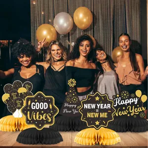 2025 New Year party decorations featuring black and gold honeycomb table centerpieces