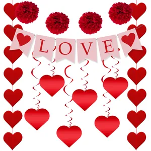 Close-up of Valentine's Day party set with pink LOVE banner and red honeycomb balls