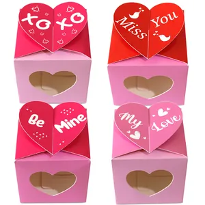 Detail of four candy gift boxes with heart-shaped cutouts and romantic messages