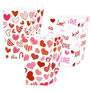 Three Valentine popcorn boxes with red hearts and Love text for party decorations