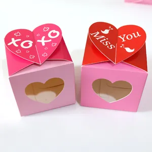 Detail of pink candy gift boxes with heart cutout windows and XOXO lids for Valentine's day