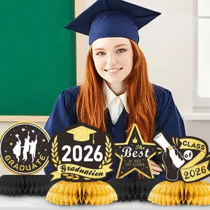Detail of 2026 graduation honeycomb centerpieces in black and gold with glitter finish