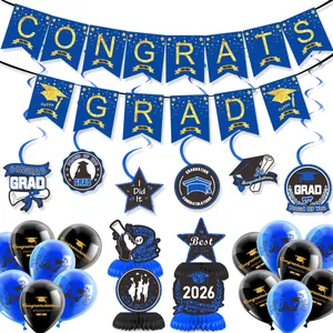 Flat lay of 2026 graduation party kit with banners, spiral charms, and honeycomb centerpieces