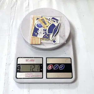 Detailed view of graduation cake topper set with blue cap design on weighing scale