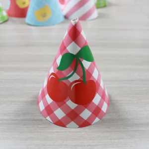 Close-up of paper party cone hats with red checkered pattern and cherry print detail