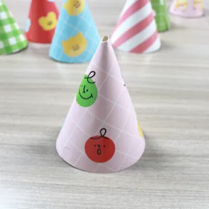 Detailed view of pink grid birthday party hat with cartoon face and colorful cone set