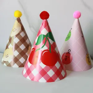 Set of three colorful cartoon birthday party cone hats with plush pom poms for children
