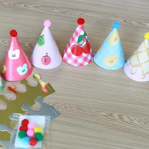 Selection of kids cartoon party cone hats with pompoms and shiny birthday crowns