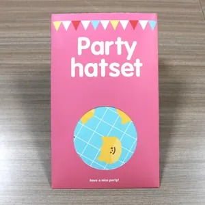 Pink packaging detail of a blue checkered party hat with a yellow cartoon cat motif
