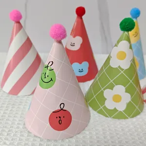 Detail of cartoon birthday party hats with colorful pom-poms and cute patterns
