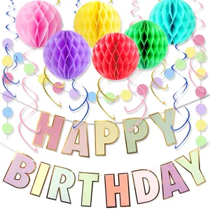 Colorful birthday party set with gold foil banner, honeycomb balls and swirls