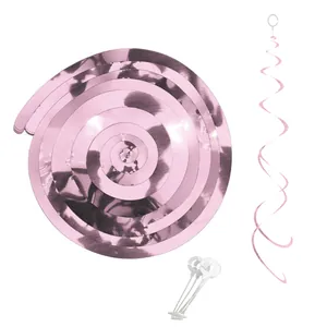 Detail of pink metallic foil swirls and plastic hooks for birthday party wall decorations