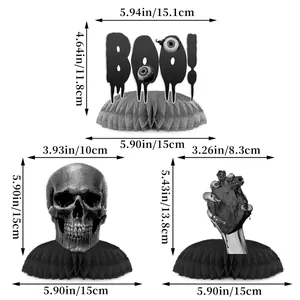Detailed view of Halloween honeycomb table centerpieces with skull and BOO letter designs