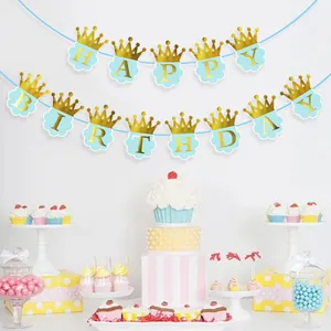 Close-up of light blue cloud-shaped happy birthday banner with golden crown detail