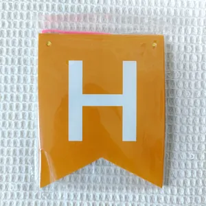 Detailed close-up of an orange swallowtail party banner flag with white letter H