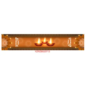 Detail of Diwali table runner featuring Happy Diwali text and traditional diya oil lamps