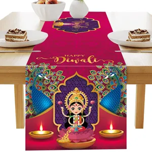 Detail of vibrant rose pink Diwali table runner with Lakshmi, Diya, and peacock patterns