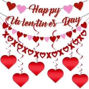 Close-up of red glitter Happy Valentine's Day banner with XOXO and heart garlands
