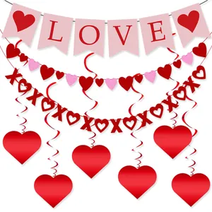 Close-up of Valentine's Day party set with BE MINE banners and XOXO heart swirls