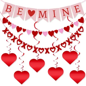 Detail showing BE MINE banner and XOXO heart garlands for Valentine party decor