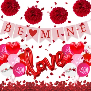 Flat lay of Valentine's set with BE MINE banner, love balloon and red rose petals