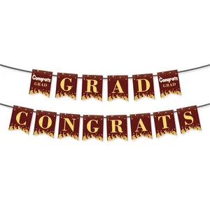 Detail of maroon graduation banners with gold foil letters and mortarboard silhouettes