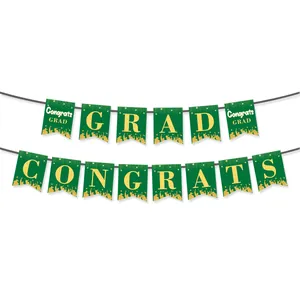 Detail of green and gold Congrats GRAD graduation banner with golden party silhouettes