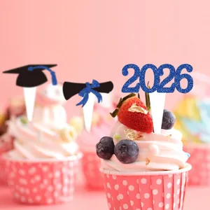Close-up of 2026 graduation cupcake toppers with blue glitter and mortarboard details