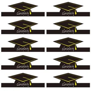 Close-up of 10-piece black congrats graduation cap paper cake toppers with yellow tassels