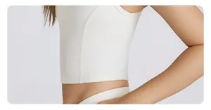 Detail shot of white yoga vest featuring structured side seams and premium elastic fabric