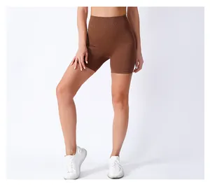Detailed close-up showing brown ribbed high-waisted seamless athletic yoga shorts