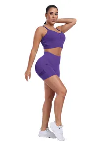Detail view of purple high-waisted yoga shorts with side mesh panels and sports bra