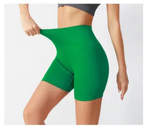 Detailed close-up of high-waist yoga shorts in green showing seamless rib stretch