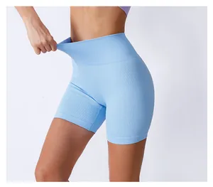 Detail showing the high elasticity of light blue seamless ribbed yoga shorts on model