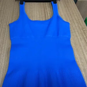 Close-up of bright blue ribbed knit yoga jumpsuit texture with wide shoulder straps