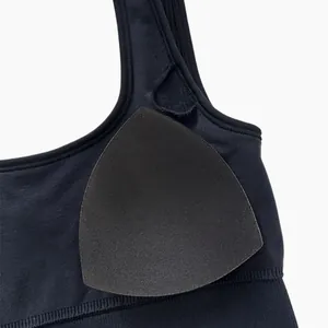 Detail of black ribbed yoga bodysuit showing removable padding and texture