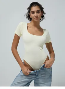 Detail of ribbed knit cream bodysuit showing high-cut leg and round neck texture