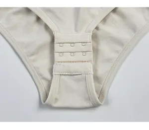 Detailed macro view of the 3-row adjustable hook-and-eye closure on beige bodysuit