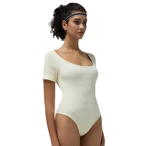 Sleeveless ribbed knit bodysuit in cream white featuring deep scoop neck and slimming fit
