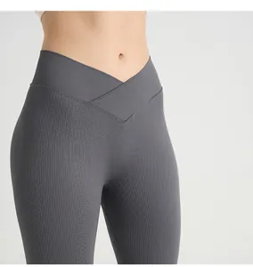Detail of dark grey ribbed yoga pants featuring a crossover V-waist design for slimming fit