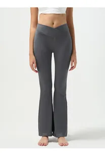 Detail of high waist V-shaped crossover waistband on dark grey ribbed yoga flare pants