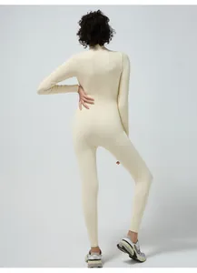 Detail of ribbed knit cream yoga jumpsuit showing high collar and seamless back texture