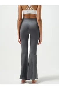 Macro shot of dark grey ribbed yoga flare pants showing high waist and booty lifting detail